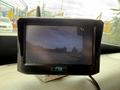 A dashboard monitor displaying a rearview image from a 2012 International TerraStar with a black frame and logo at the bottom