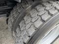 Close-up of a tire from a 2009 UD Trucks UD 3300 showing deep treads and a worn surface