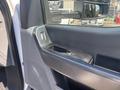 Close-up of the interior door panel of a 2023 Ford F-350 SD showing the window controls and door handle