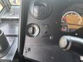 Dashboard controls of a 2018 Ford Econoline featuring dials for lights and wipers along with a tachometer