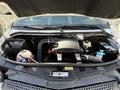 A 2016 Mercedes-Benz Sprinter engine bay showcasing the engine components including air intake hoses battery and coolant reservoir