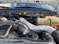 An open hood of a 2015 Ford F-550 revealing the engine compartment with various engine components and hoses visible