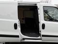 A 2017 RAM ProMaster City with its side door open revealing a spacious cargo area with a black rubber floor mat
