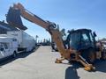 A 2016 Case 580 Super N backhoe loader with an extended arm and bucket positioned forward ready for excavation work