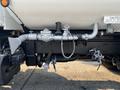 A close-up view of the underbody components of a 2016 Freightliner M2 106 including valves pipes and fittings