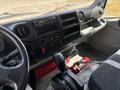 Interior dashboard of a 2018 Hino 195 featuring controls for radio climate and other functions with a gear shift and fire extinguisher visible