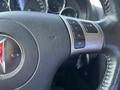 Close-up of the steering wheel of a 2006 Pontiac G6 featuring controls for audio volume and track selection