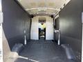 Interior of a 2022 Ford Transit with a spacious cargo area featuring a wide open floor and partition walls