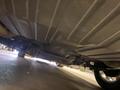 A 1968 Ford Mustang viewed from underneath showing the undercarriage components and exhaust system