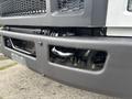 Close-up view of the front bumper and grille area of a 2018 Ford F-750 showing mechanical components and an opening in the bumper