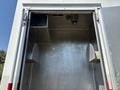 Interior view of a 2007 GMC C4500 TopKick cargo area showing metal walls and two curved shelves on each side