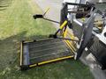 A wheelchair lift with a metal platform and yellow handles extending from the rear of a 2020 Chevrolet Express van