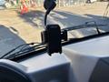 A black Arrow phone holder mounted on the dashboard of a 2022 Lion Lion6 vehicle