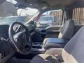 Interior view of a 2019 Ford F-150 showing the driver's seat and dashboard with a steering wheel and console in the foreground