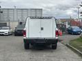 A white 2016 RAM 1500 truck facing forward with a closed rear door and no visible markings on the surface
