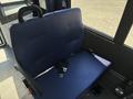 A blue fabric seat with seat belts typical of a 2020 Chevrolet Express interior