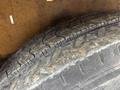 A close-up view of a worn tire showing the tread pattern and surface details