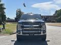 A 2022 Ford F-350 Super Duty truck in black with a chrome grille facing the camera