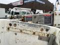 A 2009 Ford Econoline vehicle with visible signs of wear and rust on the exterior and safety warning labels attached to its parts