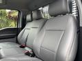 Interior view of a 2023 Ford F-450 Super Duty with gray leather seats showing front row seating and seat belts