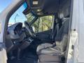 A 2024 Mercedes-Benz Sprinter 2500 interior featuring the driver's seat and dashboard with modern controls and a spacious cabin design