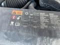 A 2013 Chevrolet Silverado 1500 hood with engine components visible and a label detailing specifications and maintenance instructions
