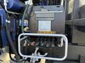Close-up of a 2015 Hino 358's hydraulic control panel featuring various levers gauges and hoses for operation