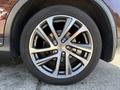 Close-up of a shiny multi-spoke alloy wheel from a 2017 Infiniti QX50 showcasing a distinct design and tire tread pattern