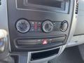 The interior control panel of a 2010 Mercedes-Benz Sprinter featuring climate control knobs and buttons for air conditioning and hazard lights