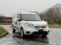 A white 2017 RAM ProMaster City van parked with a clean exterior and simple design featuring sliding side doors and a compact shape
