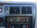 Climate control panel of a 2004 Toyota Tacoma featuring air conditioning controls and audio system display