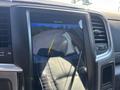A rearview camera display in a 2018 RAM 3500 showing guidelines and a view of the road behind the vehicle