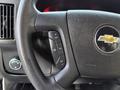 Close-up view of the steering wheel of a 2019 Chevrolet Express showing control buttons for cruise control and the Chevrolet logo