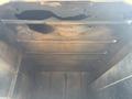 Interior view of the empty cargo area of a 2019 Freightliner M2 106 with dark surfaces and stains