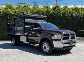 A 2015 RAM 5500 featuring a brown exterior with chrome accents and a black dump bed attached at the rear