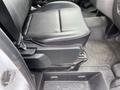 A black leather seat of a 2023 Ford Transit with adjustable features visible in the foreground