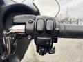 Close-up of the handlebar controls of a 2009 Harley-Davidson Road King featuring buttons for start run reset and mode selection