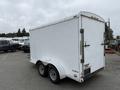 A white 2016 Continental cargo trailer with a rear ramp door and double axles visible from the side angle