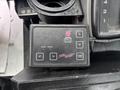 Close-up of a black control box labeled Traffic Manager with buttons for function, diagnostic, and power enter displaying a series of indicator lights