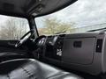 Interior view of a 2016 Peterbilt 348 truck with a dark leather driver's seat and a dashboard featuring gauges and controls
