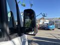 A 2021 Mercedes-Benz Sprinter 2500 with a side mirror reflecting a worksite and machinery in the background