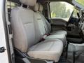 Interior view of a 2021 Ford F-350 SD showing two front seats with gray upholstery and seat belts