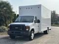 A white 2008 Ford Econoline box truck with a large cargo box and black front grille parked on a driveway
