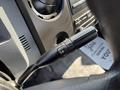 Close-up of a control stalk inside a 2018 Ford F-750 used for adjusting various settings with a plus and minus button