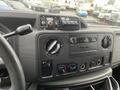 Dashboard of a 2009 Ford Econoline featuring various controls including climate settings and audio system components