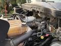 Close-up of the engine compartment of a 2013 International Durastar 4300 showcasing the engine components and various hoses and connections