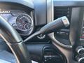 The interior dashboard of a 2021 RAM 5500 showing the speedometer, gear shift lever, and various control knobs