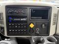 Dashboard of a 2013 International Workstar 7500 featuring gauges buttons and a radio display with various controls and a key holder