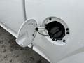 A close-up view of the fuel filler cap on a 2012 GMC Canyon with the cap partially open and a tether attached to the vehicle