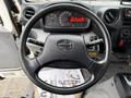 Close-up of the steering wheel of a 2015 Hino 195 showing the dashboard with an odometer and various controls